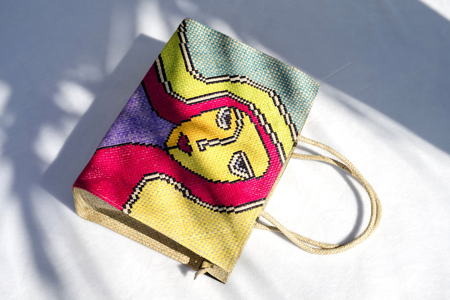 Side view of the Reyna Woven Handbag, showcasing its handcrafted design and spacious interior.