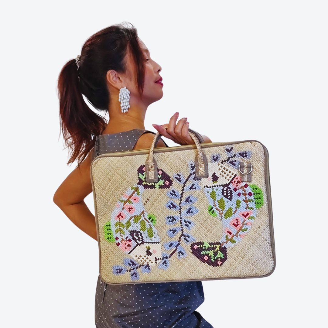 A person holding the Ying Yang Woven Laptop Bag outdoors, highlighting the stylish and durable design crafted by Filipino artisans.