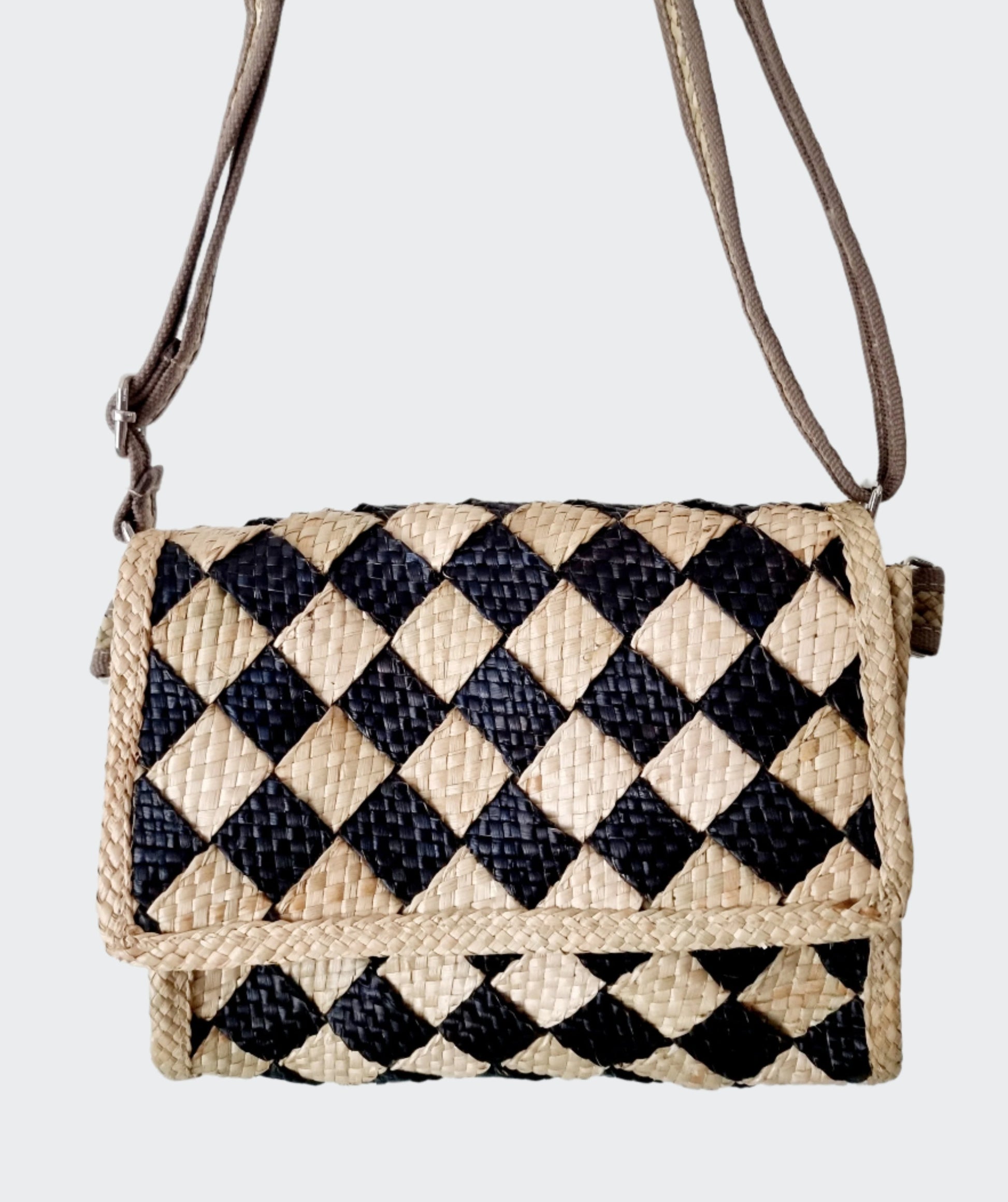 Talunay Black Woven Sling Bag made from eco-friendly seagrass, featuring durable double-woven straps and intricate handmade craftsmanship.